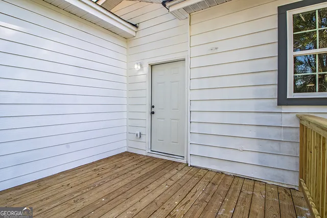 a view of a house with wooden deck