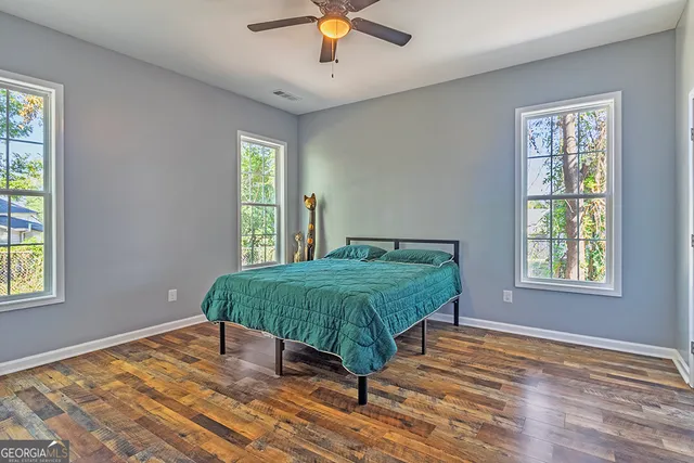 a bedroom with a bed and window