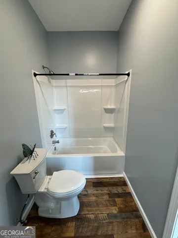 a bathroom with a toilet and a bathtub