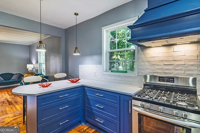 a kitchen with a stove and a wooden cabinets
