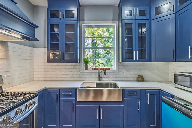 a kitchen with a sink cabinets and window