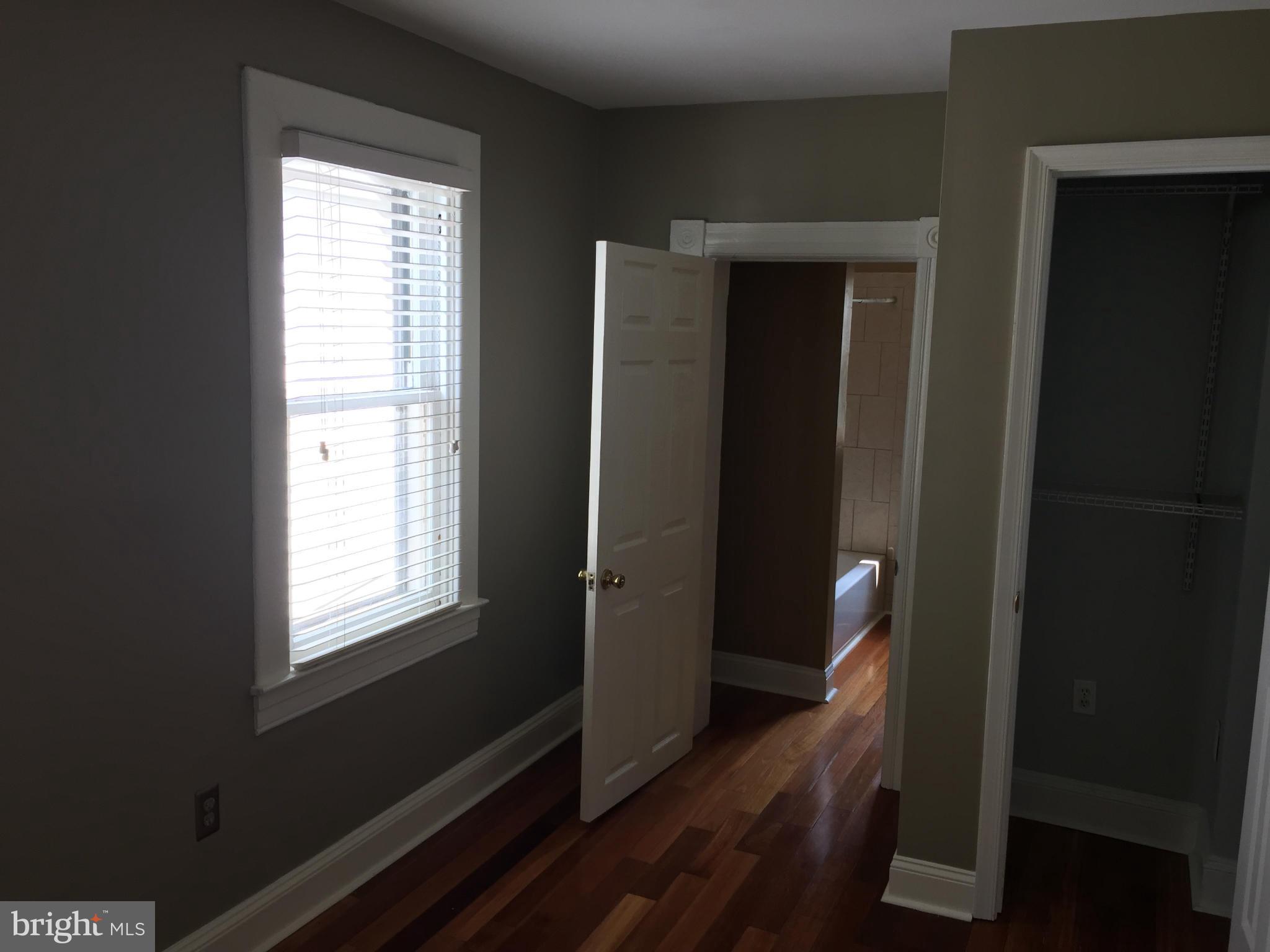 3131 Elliott Street Baltimore, MD 21224 - Photo 11 of 14 a view of a hallway with wooden floor and stairs