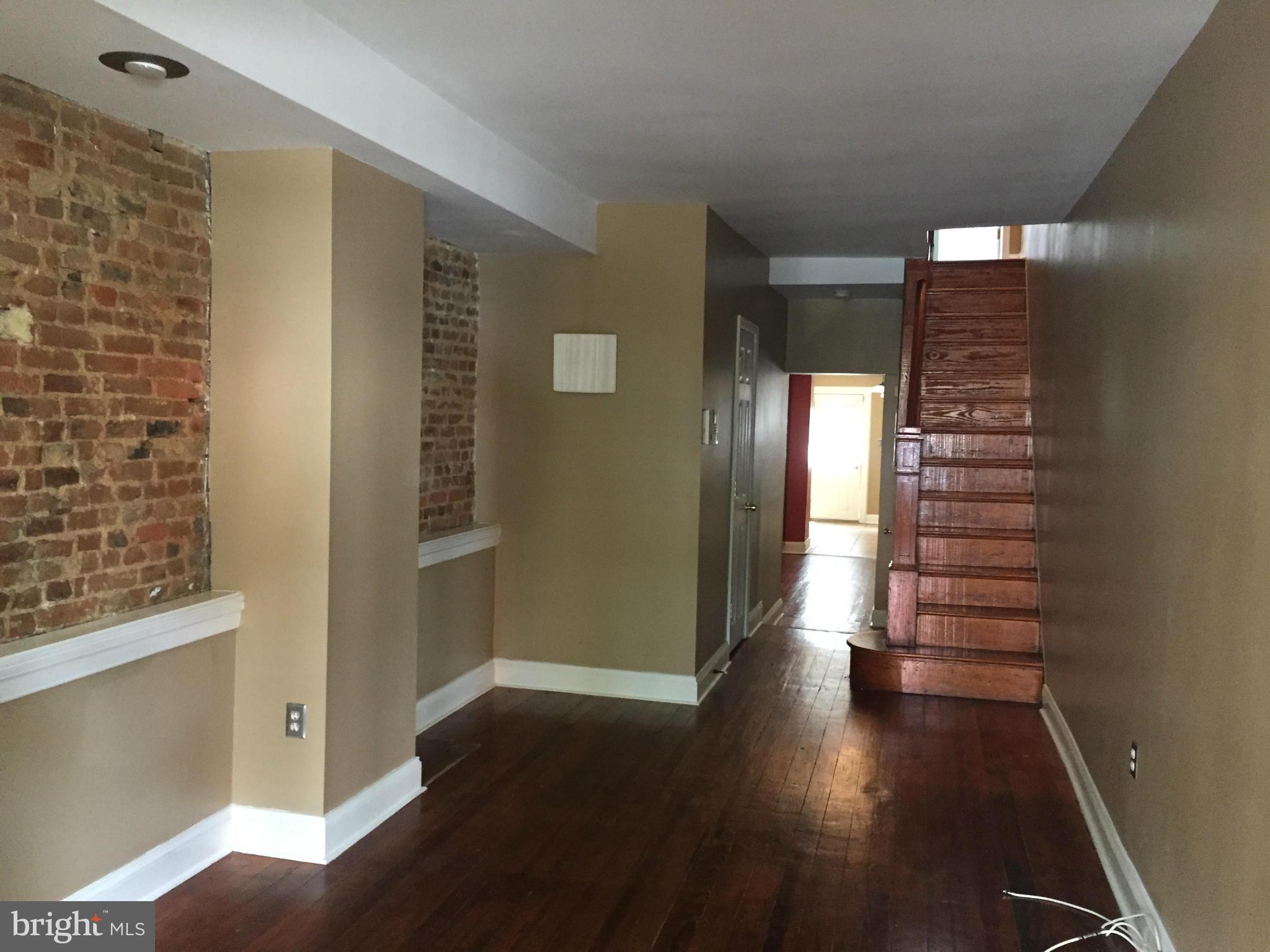 3131 Elliott Street Baltimore, MD 21224 - Photo 4 of 14 a view of entryway with stairs and wooden floor