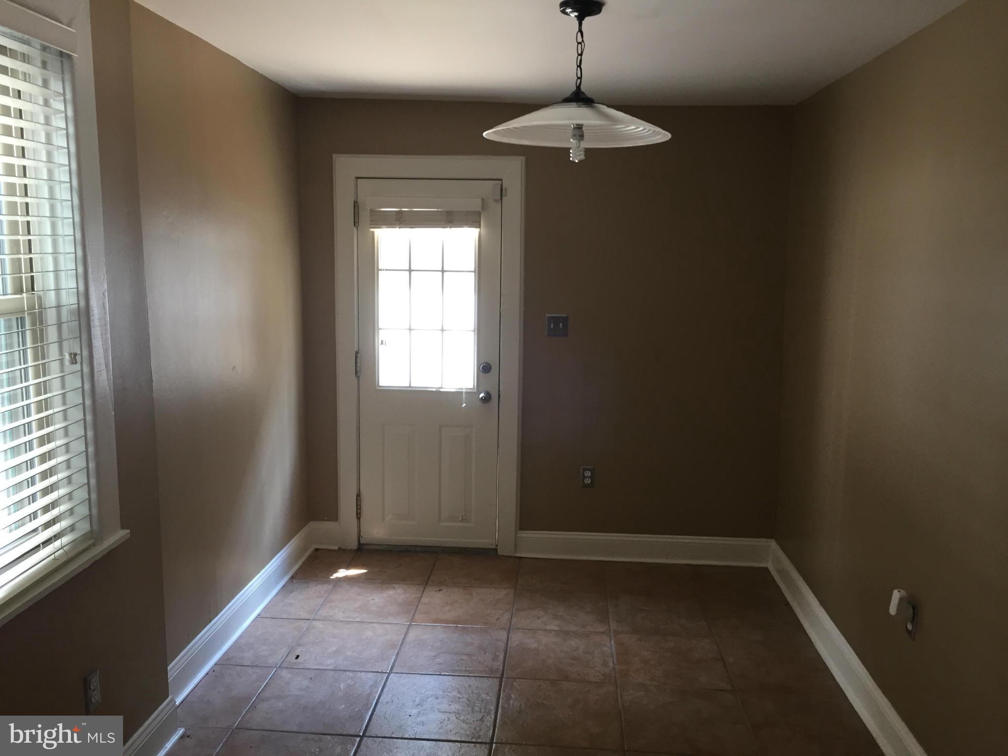 3131 Elliott Street Baltimore, MD 21224 - Photo 6 of 14 a view of entryway with window and chandelier fan