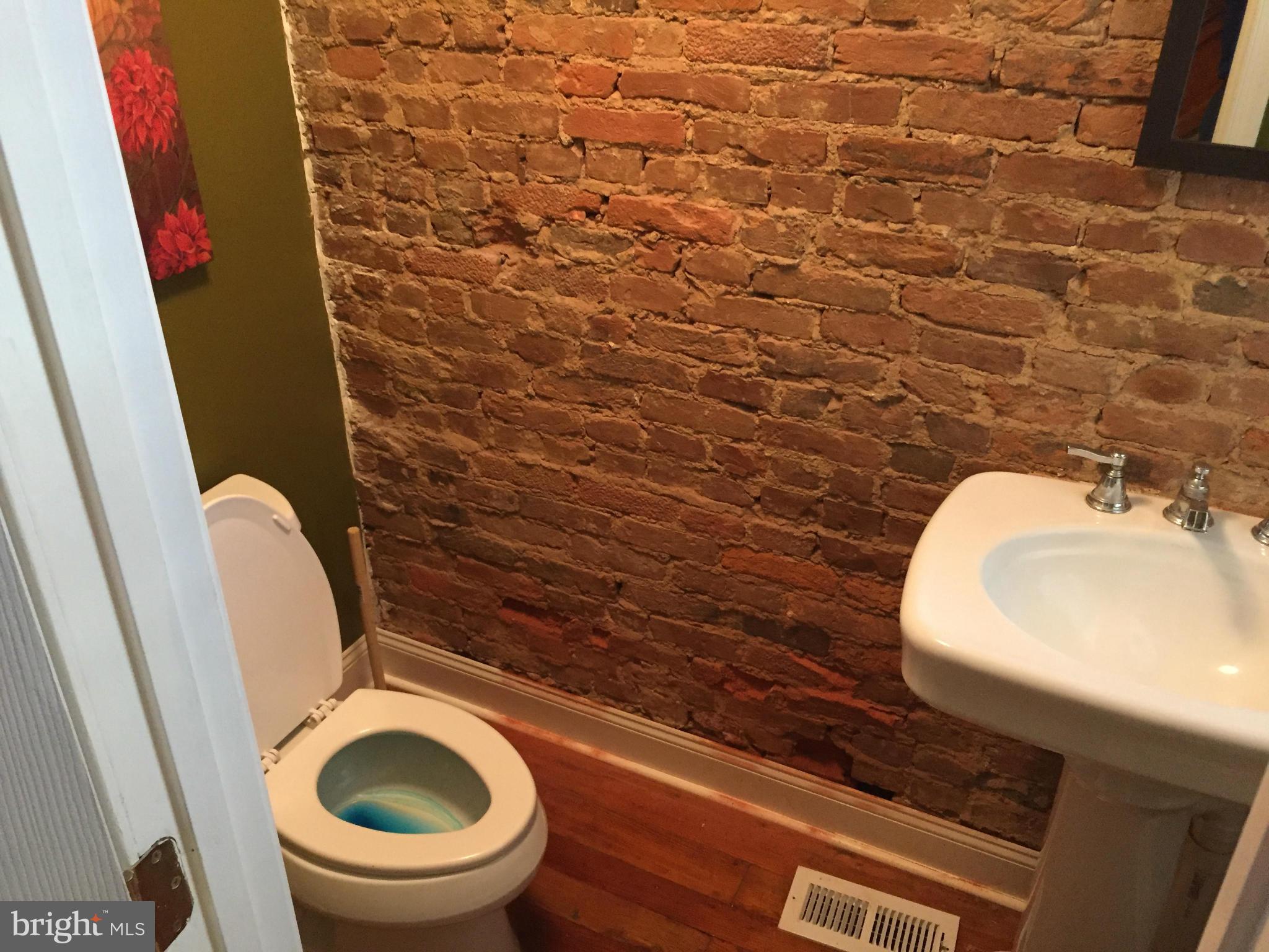 3131 Elliott Street Baltimore, MD 21224 - Photo 7 of 14 a bathroom with a toilet and a sink