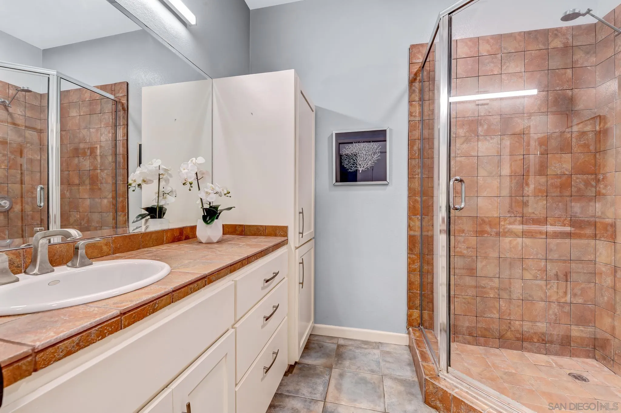5370 La Jolla Boulevard, Unit 201B La Jolla, CA 92037 - Photo 12 of 31 a bathroom with a double vanity sink mirror and shower