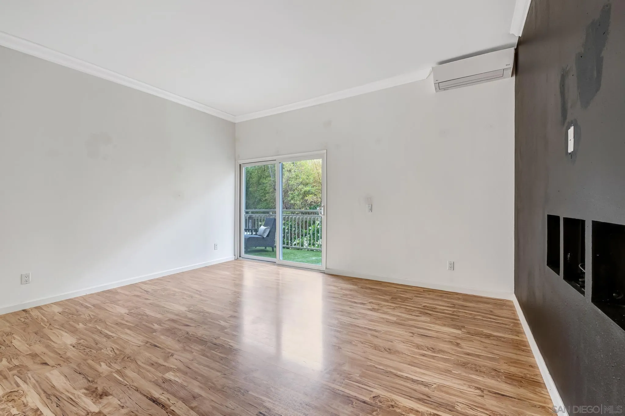 5370 La Jolla Boulevard, Unit 201B La Jolla, CA 92037 - Photo 13 of 31 a view of an empty room with wooden floor and a window