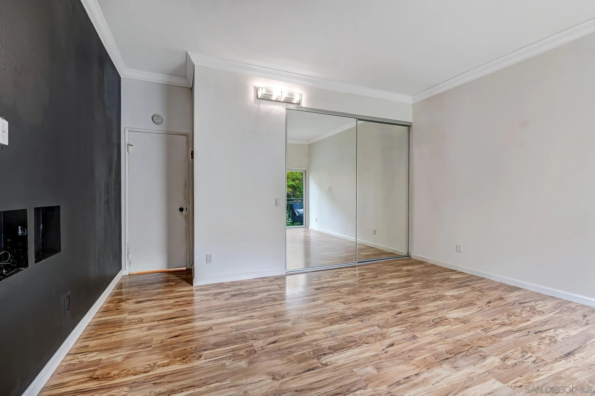 5370 La Jolla Boulevard, Unit 201B La Jolla, CA 92037 - Photo 14 of 31 a view of an empty room with wooden floor and a bathroom