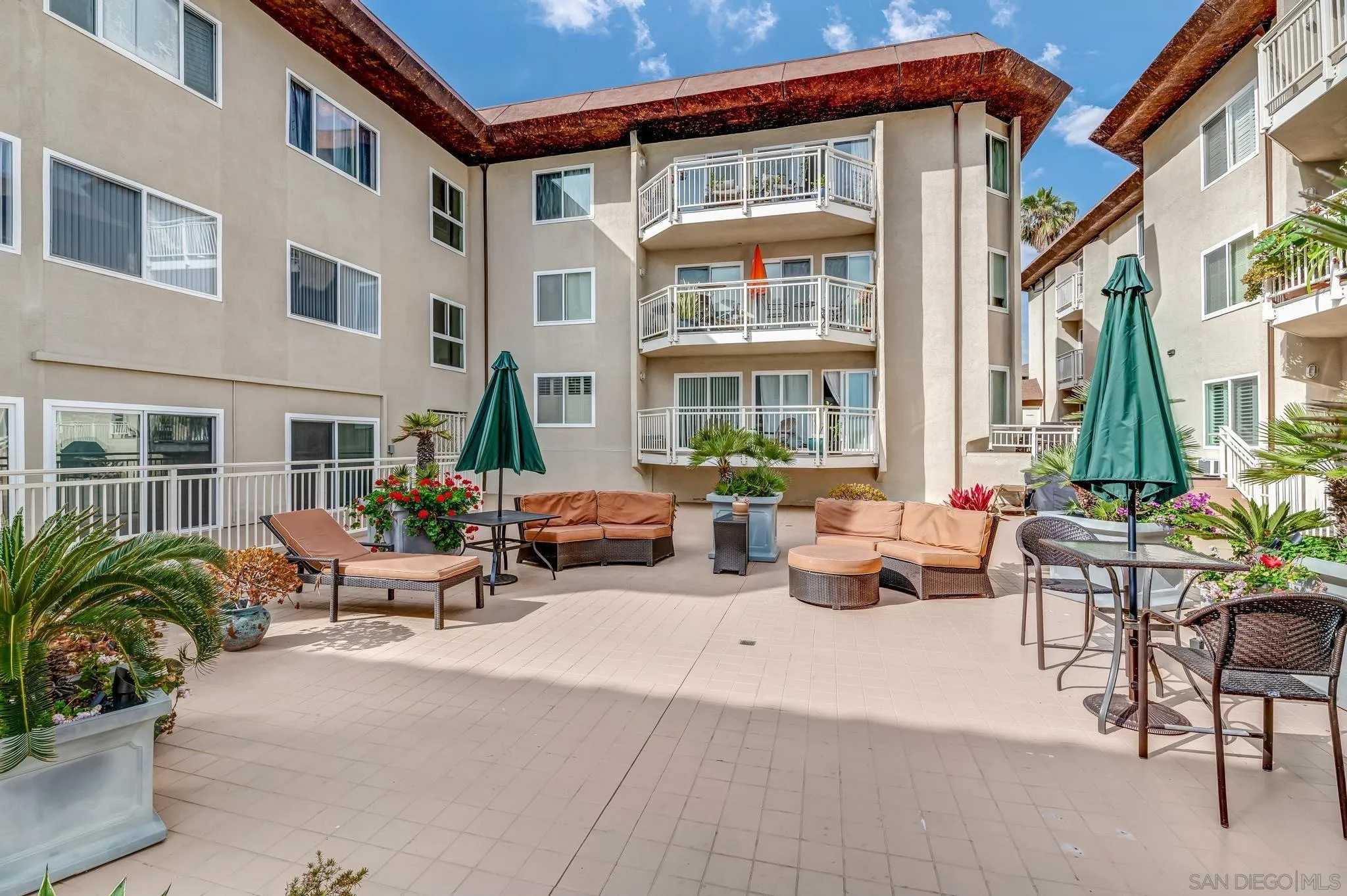5370 La Jolla Boulevard, Unit 201B La Jolla, CA 92037 - Photo 25 of 31 a view of a patio with couches and a table and chairs