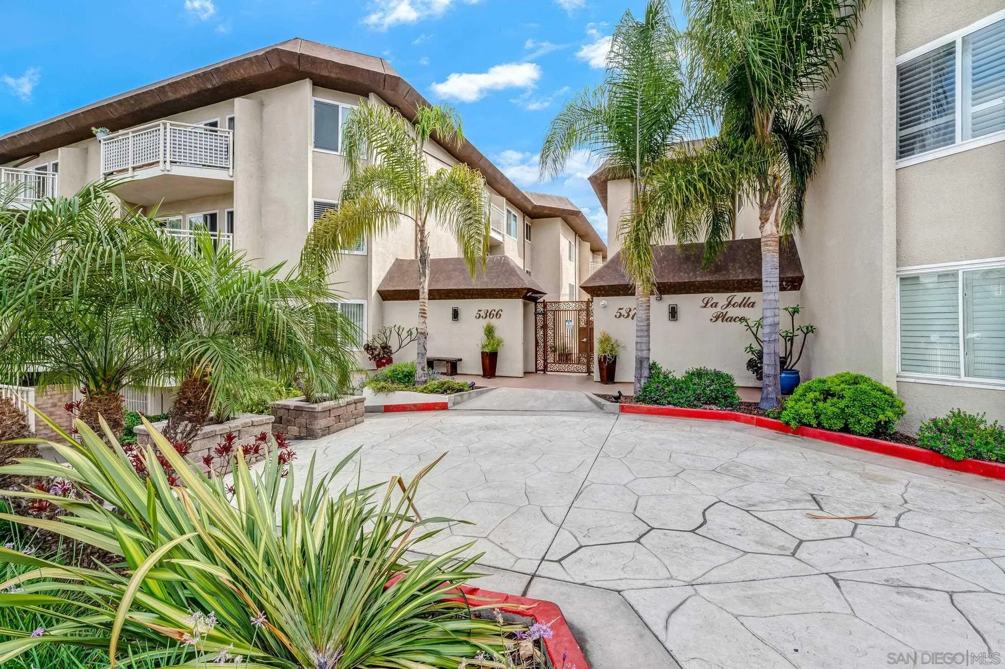 5370 La Jolla Boulevard, Unit 201B La Jolla, CA 92037 - Photo 27 of 31 a front view of a house with a yard and potted plants