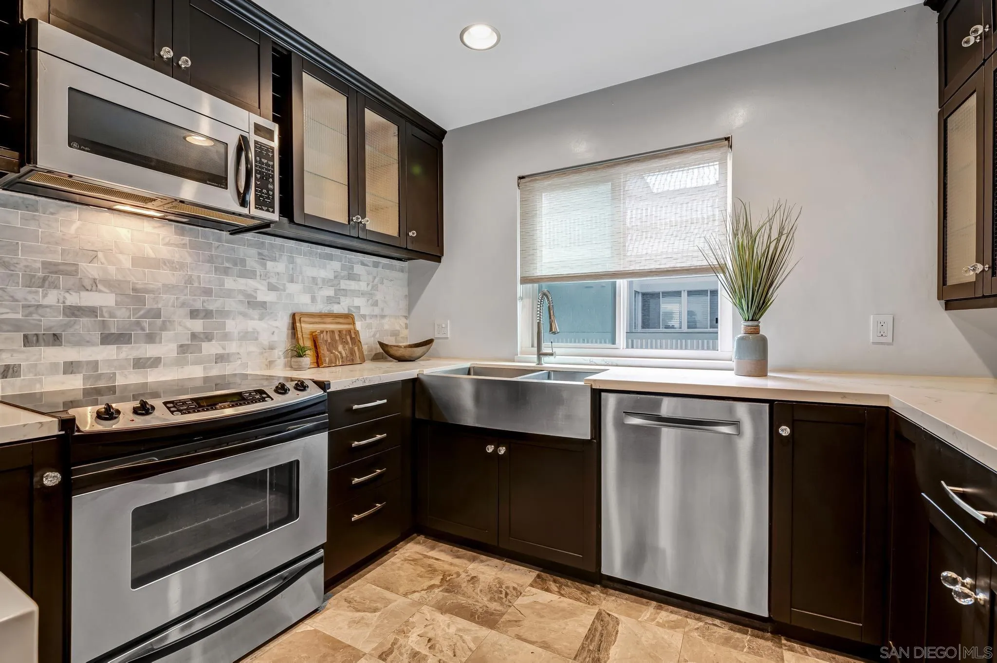 5370 La Jolla Boulevard, Unit 201B La Jolla, CA 92037 - Photo 6 of 31 a kitchen with stainless steel appliances granite countertop a stove microwave and sink