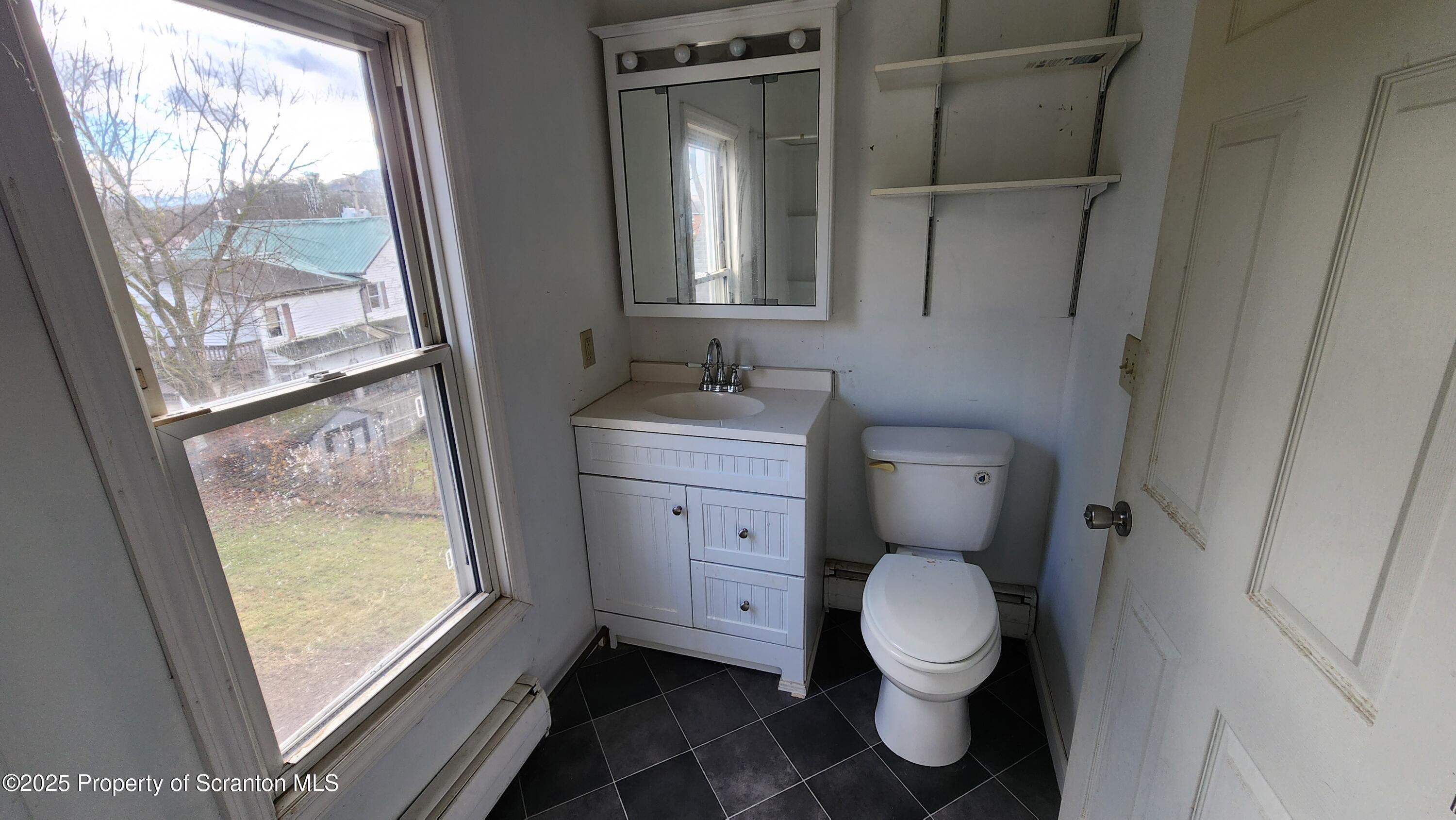40 William Street Hallstead, PA 18822 - Photo 16 of 31 a bathroom with a toilet sink and mirror