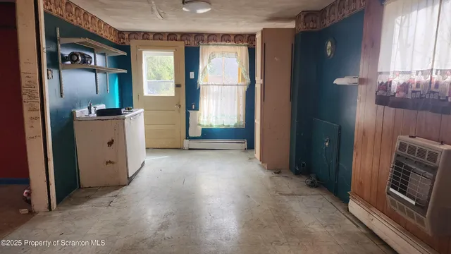 a view of a kitchen with a sink and cabinet area
