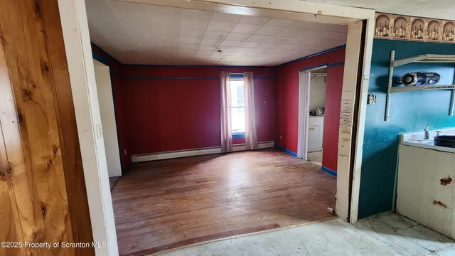 a view of a hallway with wooden shelves