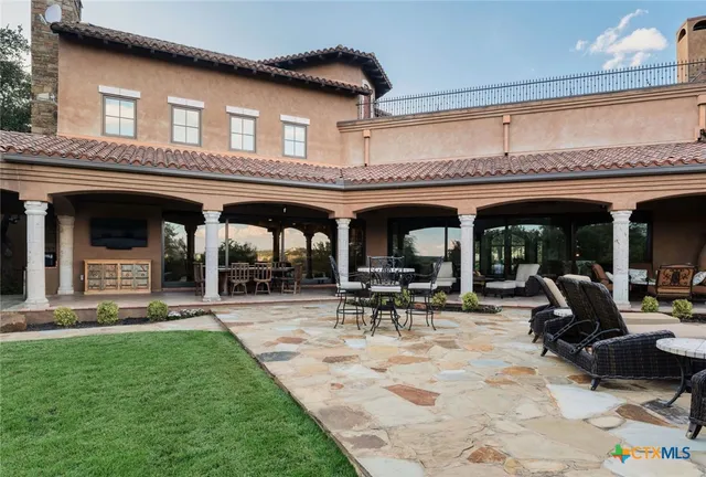 a view of a porch with furniture and garden