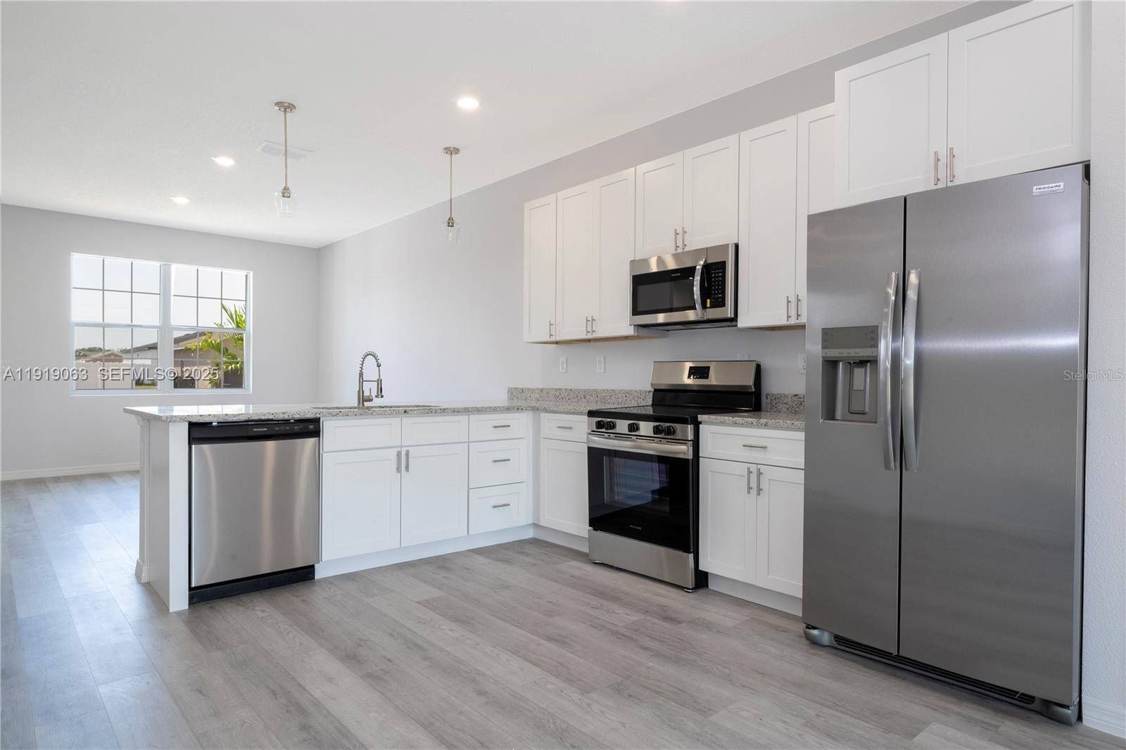 833 Colville Drive, Unit 833 Kissimmee, FL 34759 - Photo 15 of 47 a kitchen with a refrigerator and a stove top oven