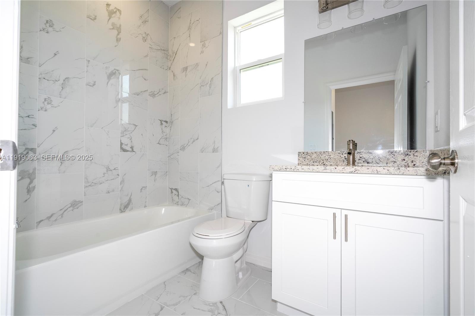 833 Colville Drive, Unit 833 Kissimmee, FL 34759 - Photo 40 of 47 a bathroom with a sink toilet and shower