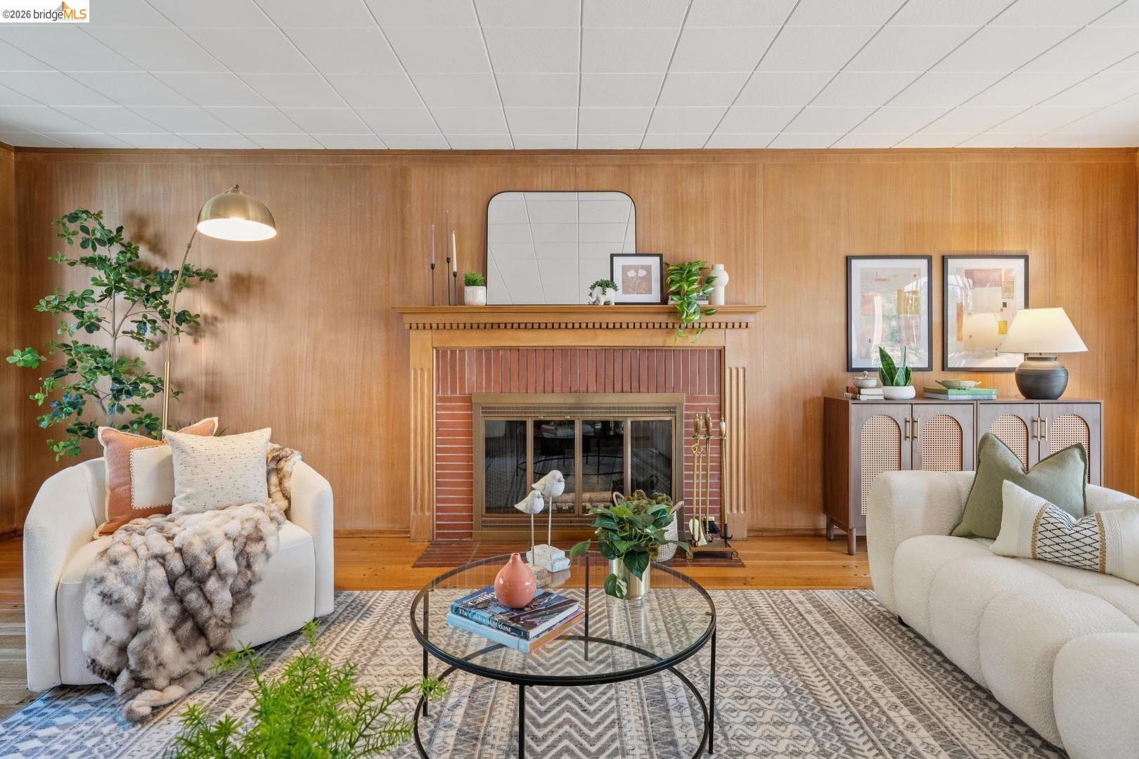 155 Avenida Drive Berkeley, CA 94708 - Photo 10 of 86 Wood-paneled accent wall with a brick fireplace and wood mantel
