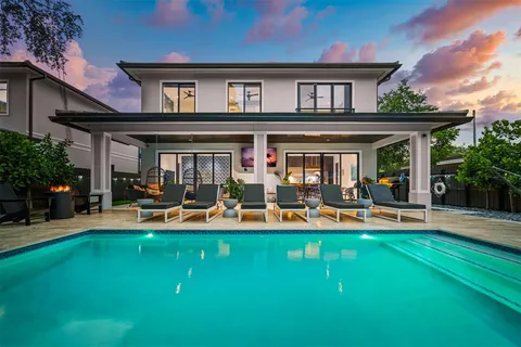 a front view of a house with patio and garden