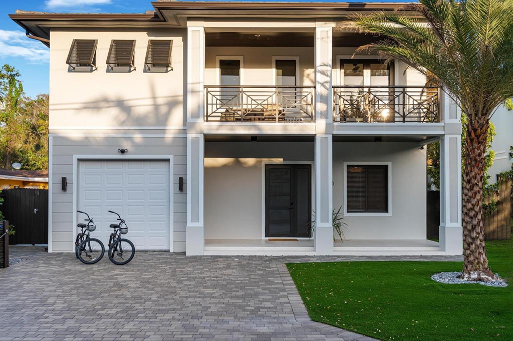 620 Southwest 12th Avenue Fort Lauderdale, FL 33312 - Photo 2 of 49 a view of a house with a large windows and a yard with wooden fence