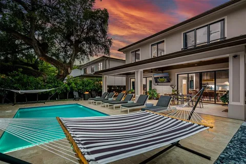 a view of a house with backyard porch and sitting area