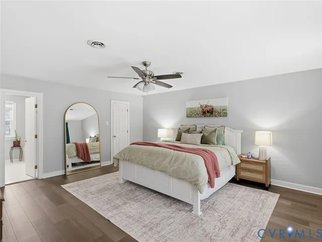 a spacious bedroom with a bed and dresser