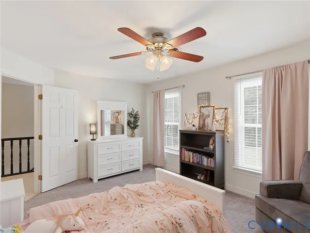 a bedroom with a bed and a television