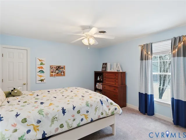 a bedroom with a bed dresser and a window