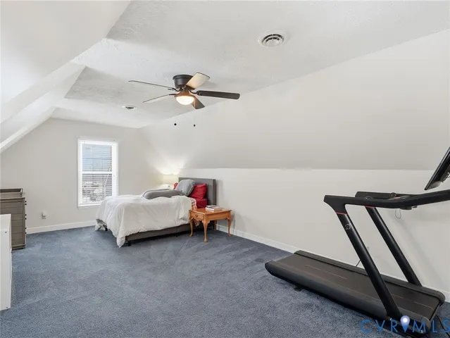 a bed room with furniture and white walls