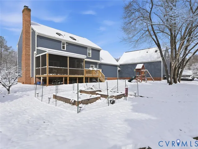 a view of a building with a backyard and a large tree