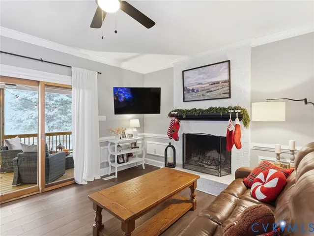 a living room with furniture a flat screen tv and a fireplace