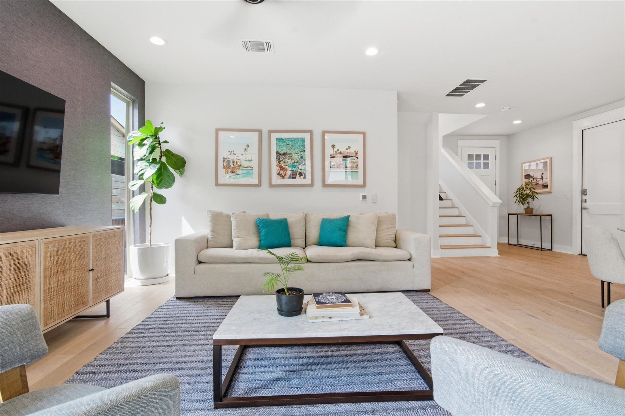 2710 Zaragosa Street, Unit A Austin, TX 78702 - Photo 3 of 29 Light-filled open living space with wide-plank floors and a staircase that anchors the home's three-level flow.