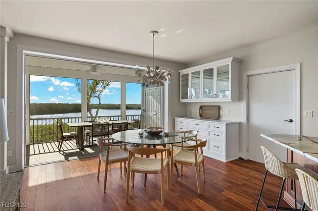 a dining room with furniture window and wooden floor