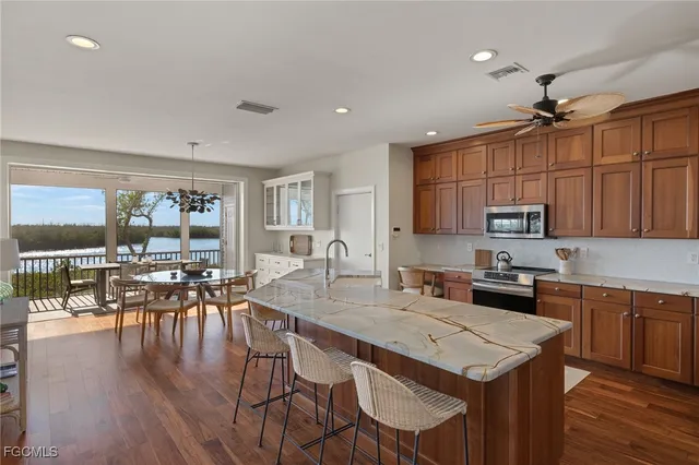 a kitchen with a table chairs stove and cabinets