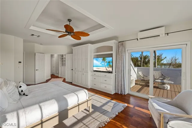 a bedroom with a balcony a bed and a chandelier