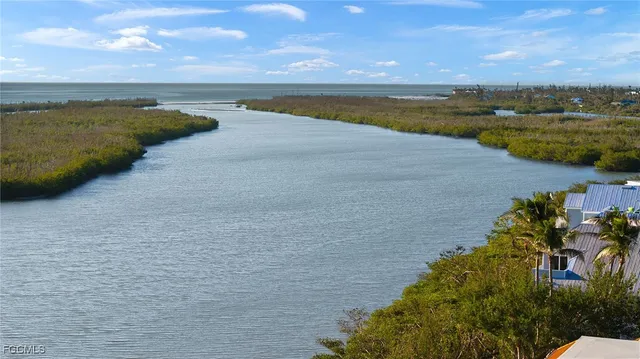 a view of an ocean with city and mountain view