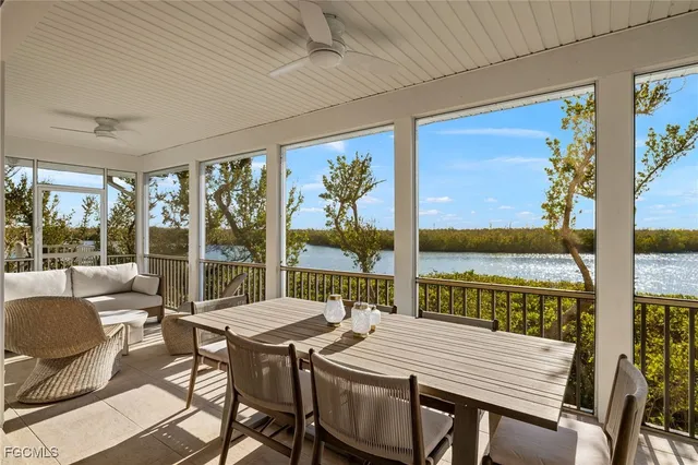 a view of a dining room with furniture large windows and wooden floor