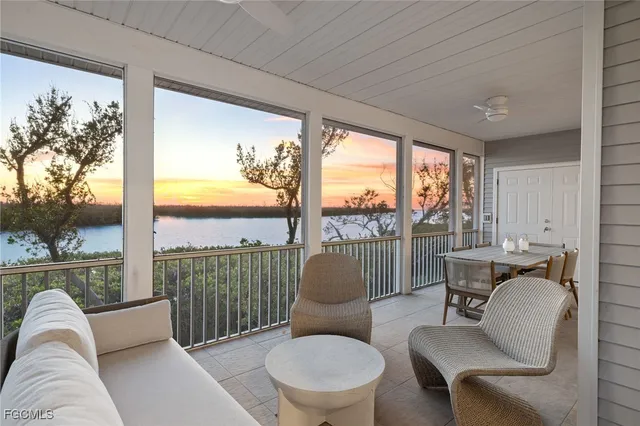 a living room with furniture and a floor to ceiling window