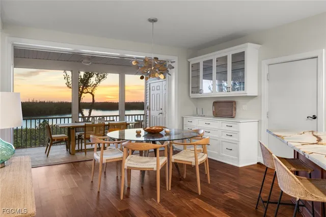 a dining room with furniture window and wooden floor