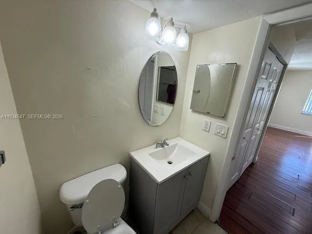a bathroom with a toilet sink and mirror