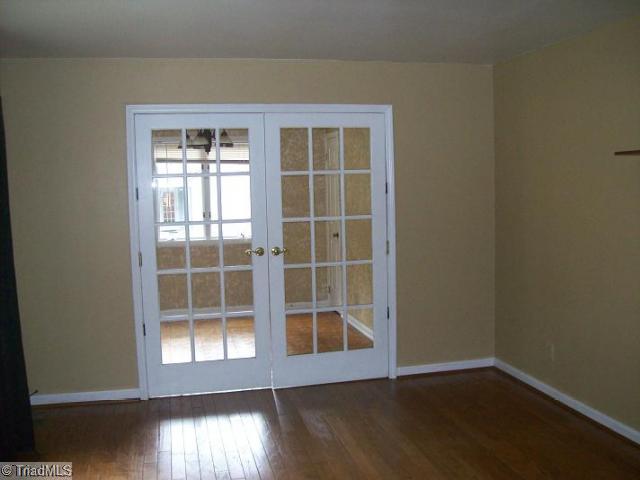 1706 Three Meadows Road Greensboro, NC 27455 - Photo 8 of 12 Exterior Front. Living Room, Dining Room behind French Doors