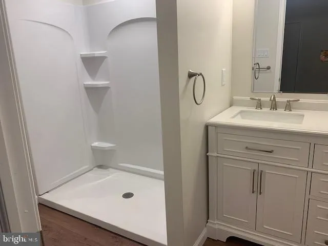 a bathroom with a granite countertop sink a toilet and a mirror
