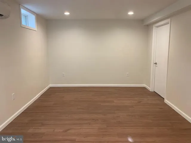 a view of room with wooden floor