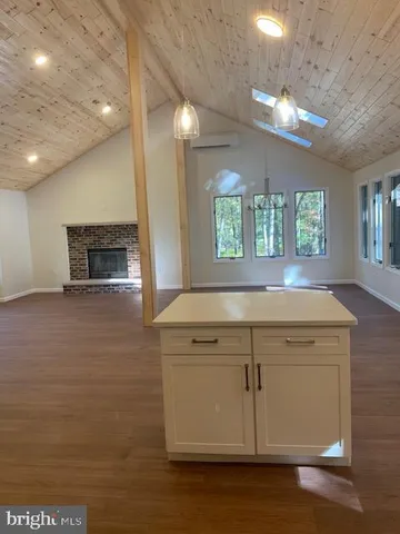 a view of a kitchen with an empty space and window