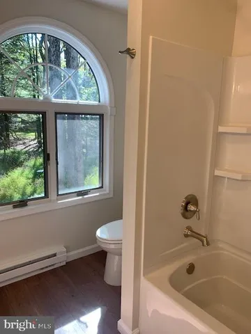 a bath tub sitting next to a window