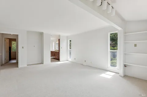 an empty room with a empty space and windows