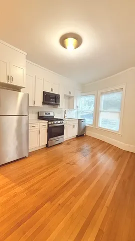 a kitchen with stainless steel appliances a refrigerator a stove a sink and a microwave