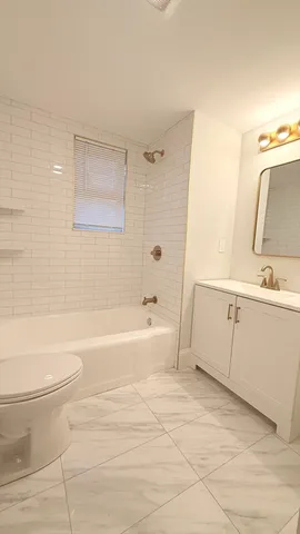 a bathroom with a bathtub toilet and sink