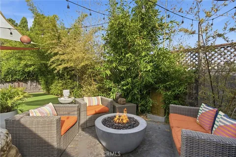 a view of a patio with couches chairs and a potted plant