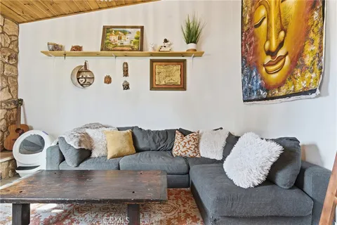 a living room with furniture and painting on the wall